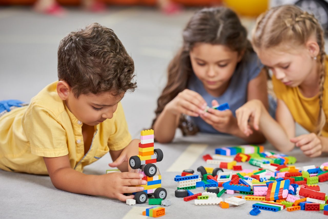 bright stars children playing together in the classroom in kindergarten